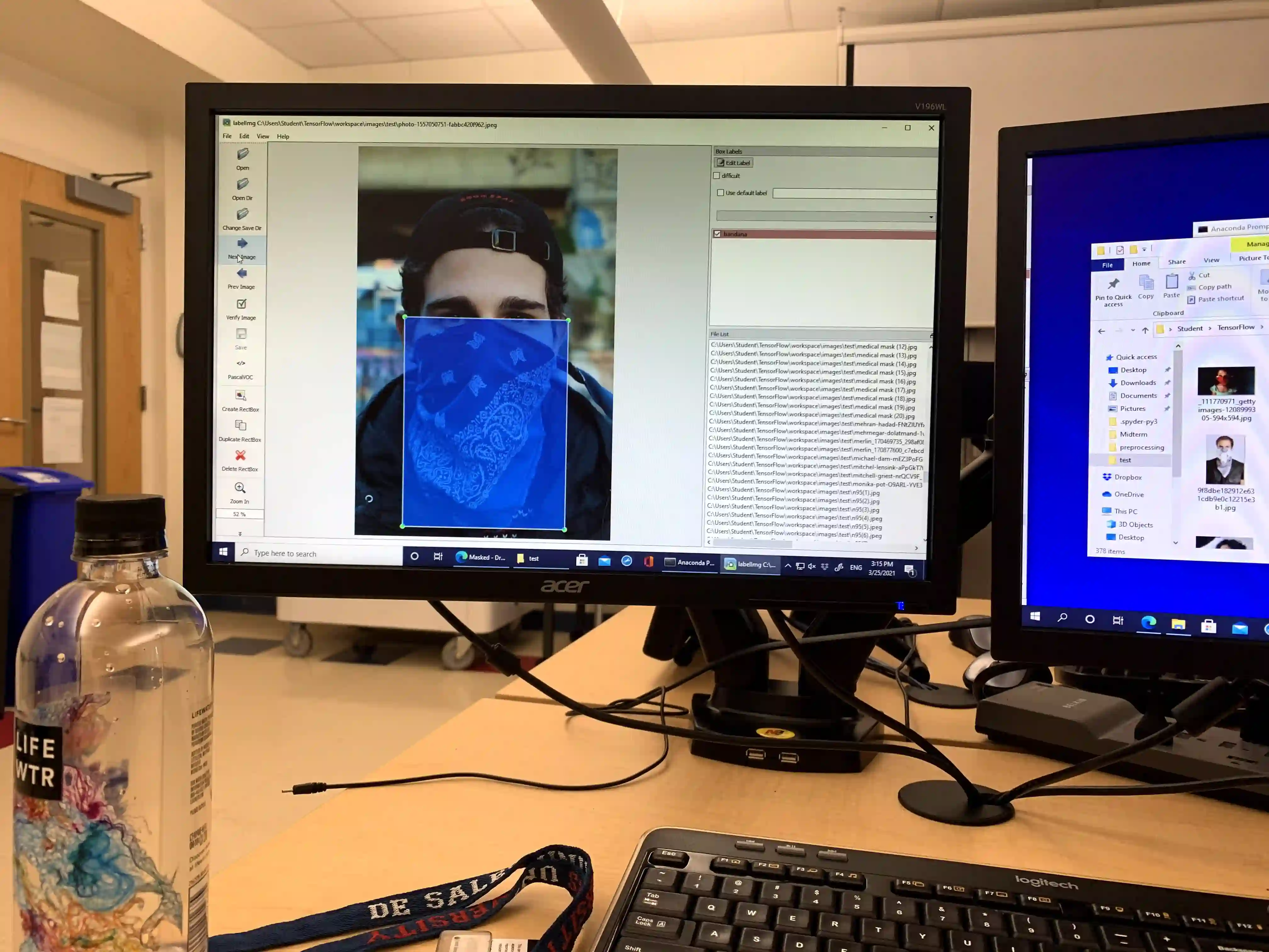 computer displaying masked person with a blue box highlighting the photo